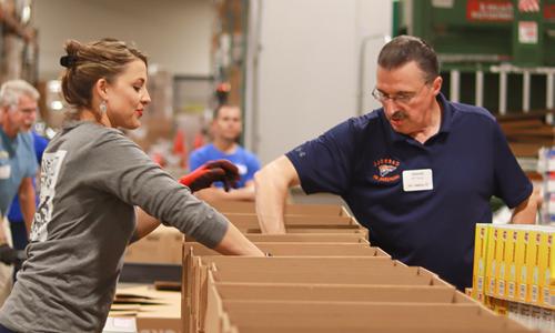 Alumni packing donated goods